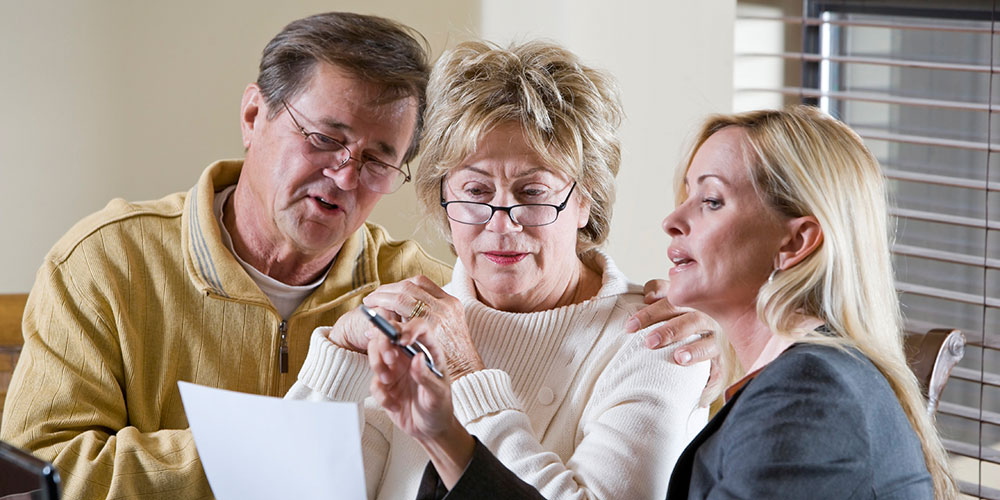 man and two women reviewing document