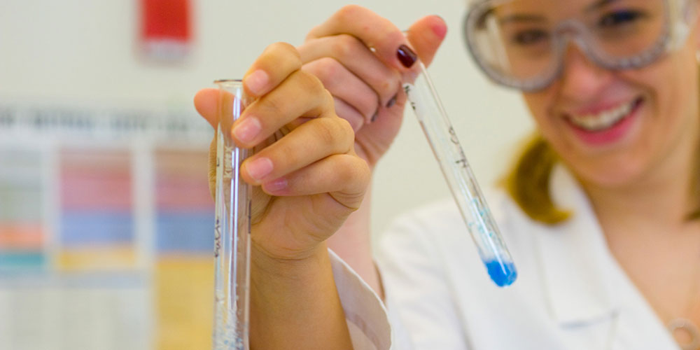 student holding test tube